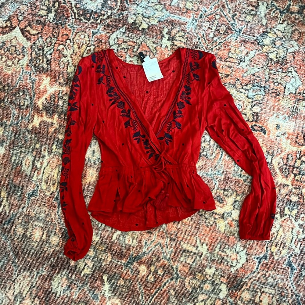 Red blouse with navy blue embroidery